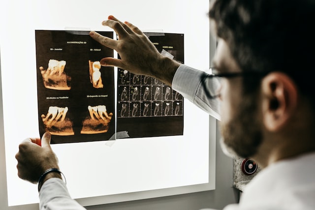 Dentist examining a dental x-ray
